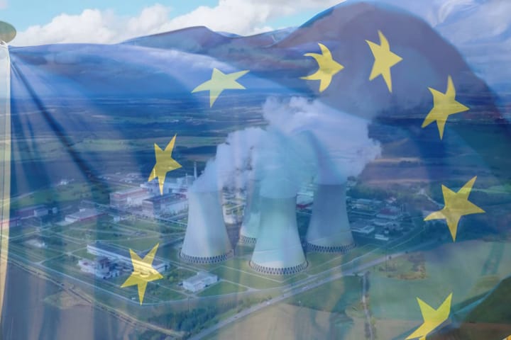 Photo of a nuclear powerplant with a transparent EU flag waving on top of it.